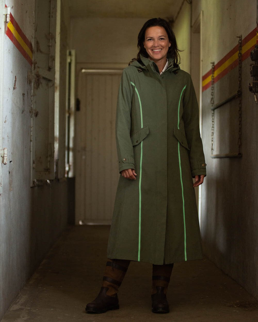 Grey Green Coloured Baleno Kensington Safe Womens Long Riding Coat On A Stable Background 