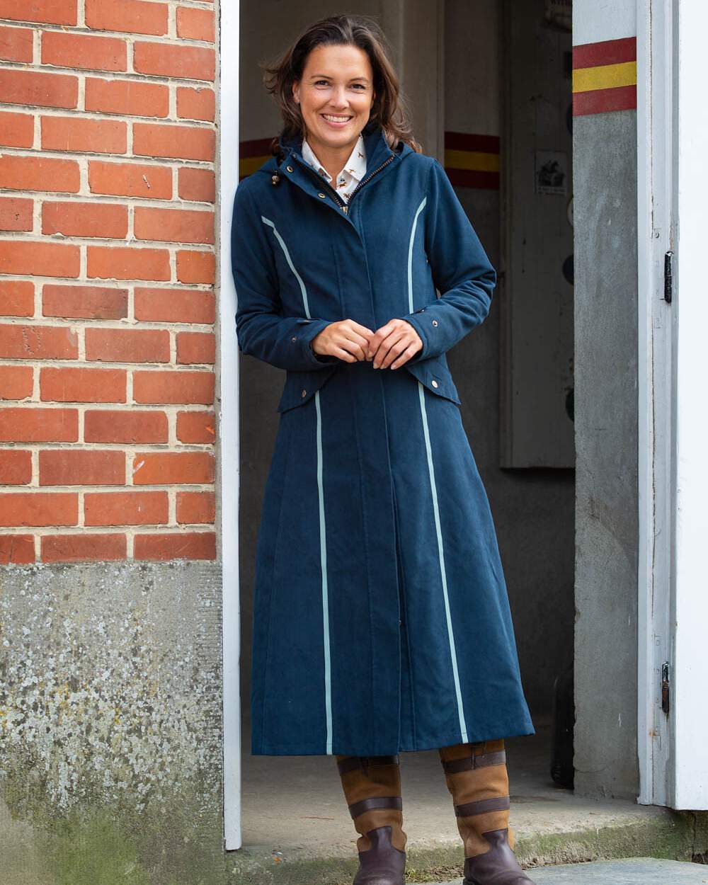 Navy Blue Coloured Baleno Kensington Safe Womens Long Riding Coat On A Stable Background 