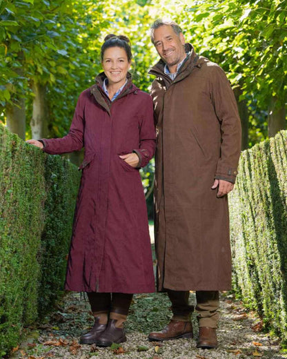 Earth Brown Coloured Baleno Livingstone Long Waterproof Coat On A Countryside Background 