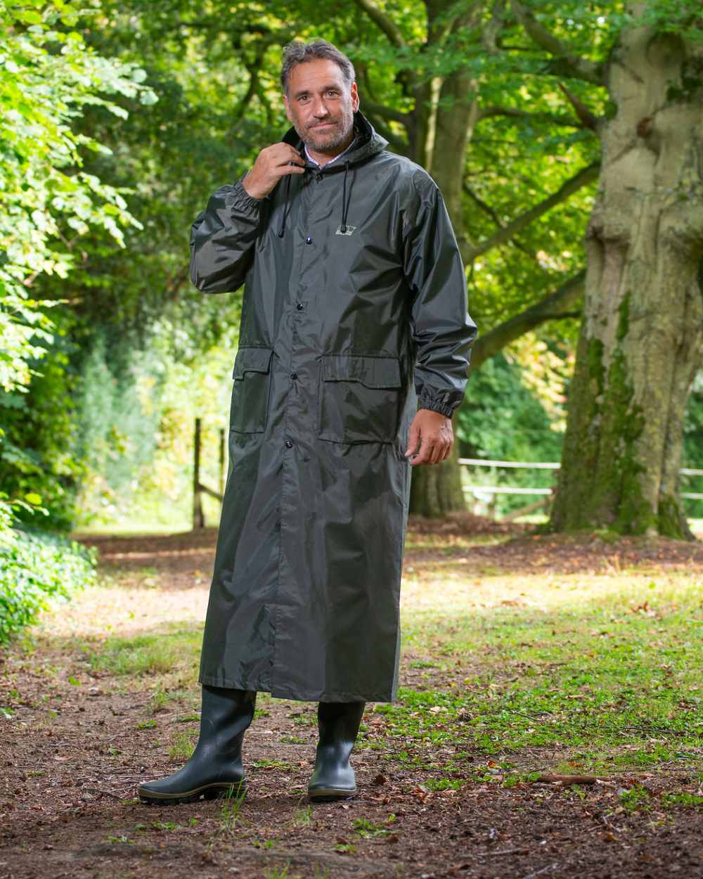 Green Khaki Coloured Baleno Montana Long Raincoat On A Stable Background