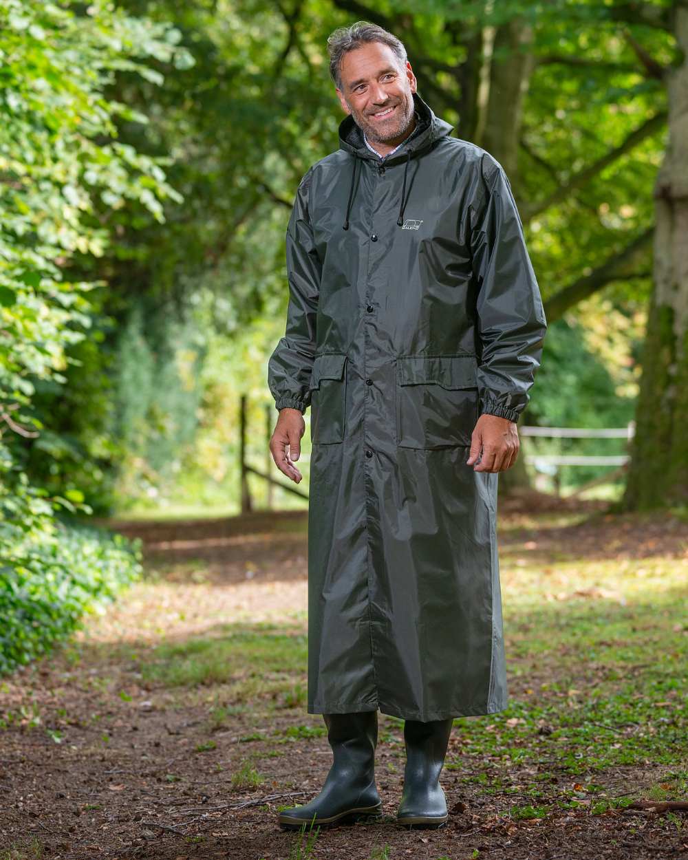 Green Khaki Coloured Baleno Montana Long Raincoat On A Stable Background