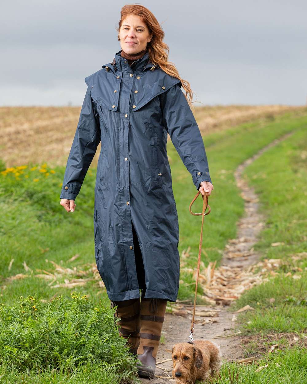 Navy Coloured Baleno Oxford Long Waterproof Coat On A Backyard Background 