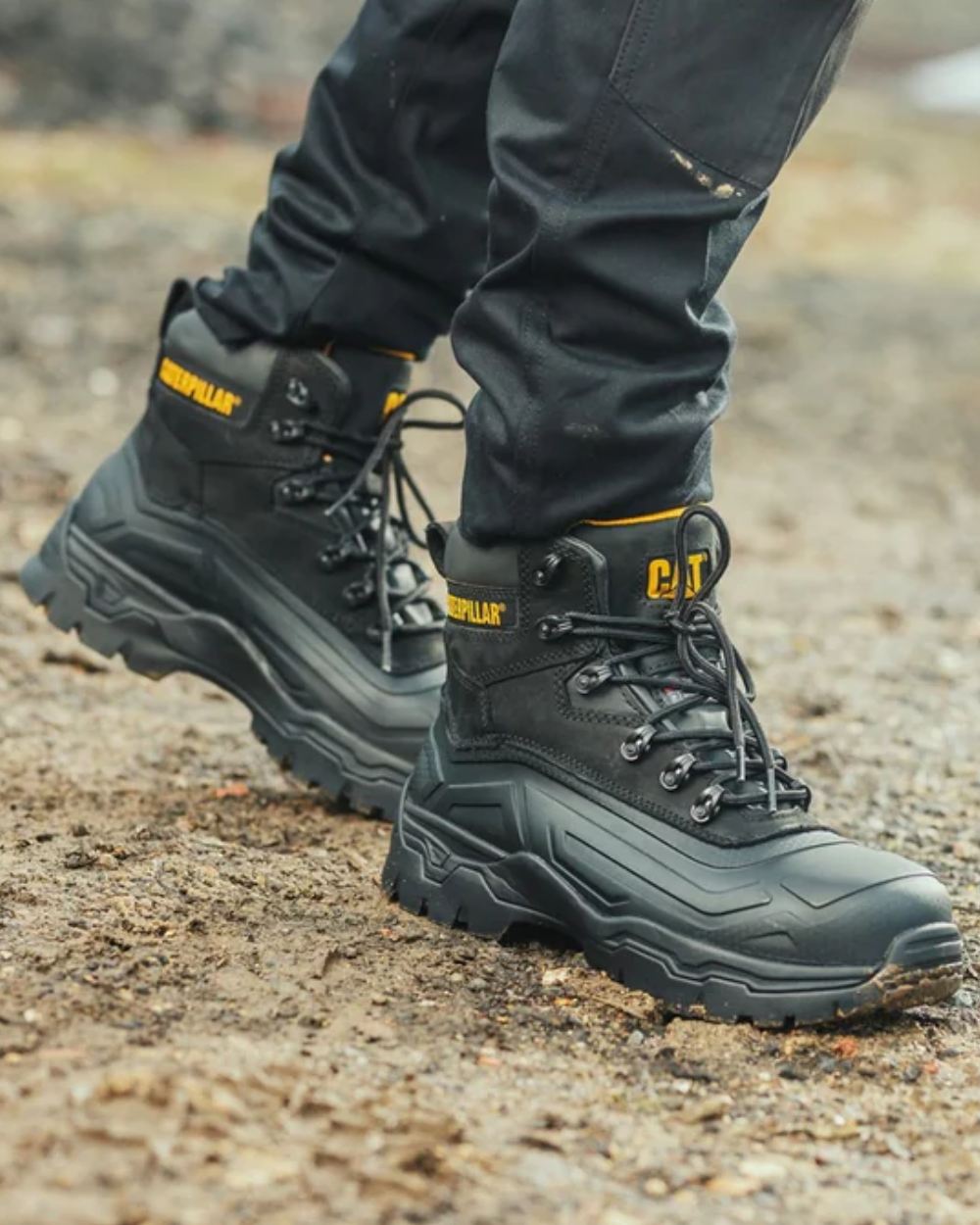 Black Coloured Caterpillar Typhoon SBH Safety Boot On A Street Background