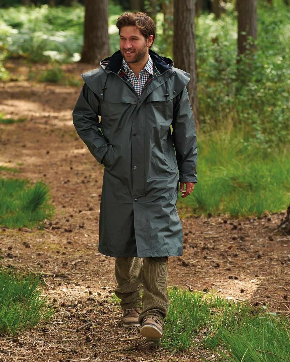 Olive Coloured Champion Highgrove Long Waterproof Coat On A Forest Background 