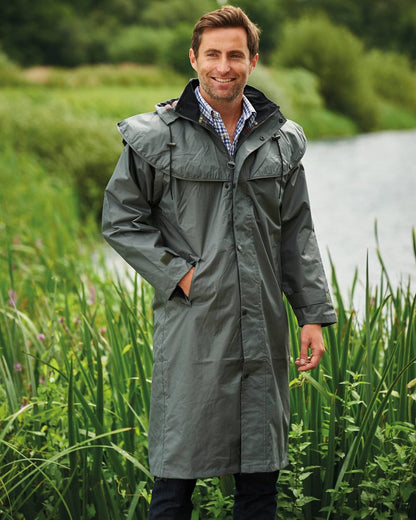 Olive Coloured Champion Highgrove Long Waterproof Coat On A Lake Background 