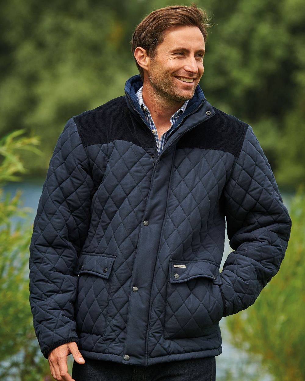 Navy Coloured Champion Lewis Diamond Quilted Jacket On A Lake Background 