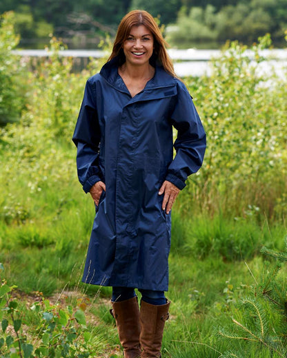 Navy Coloured Champion Storm Long Waterproof Coat On A Countryside Background