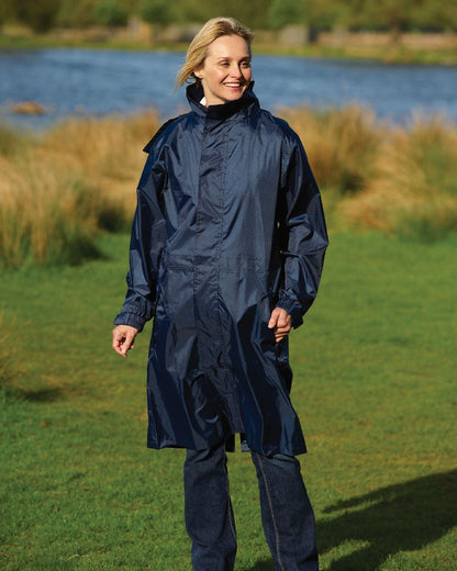 Navy Coloured Champion Storm Long Waterproof Coat On A Countryside Background