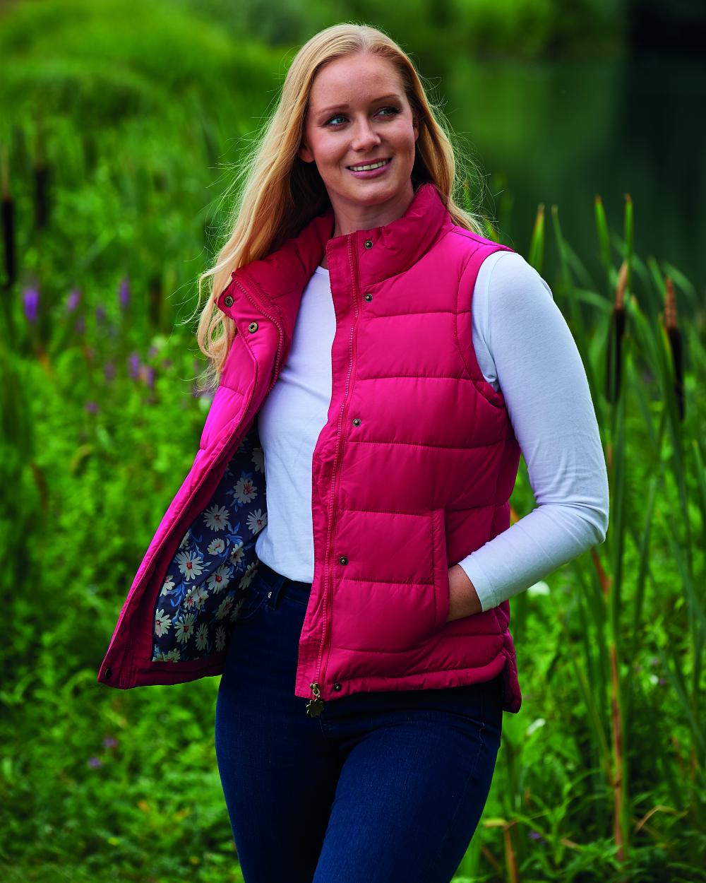 Rose Coloured Champion Vermont Ladies Quilted Gilet On A Field Background 