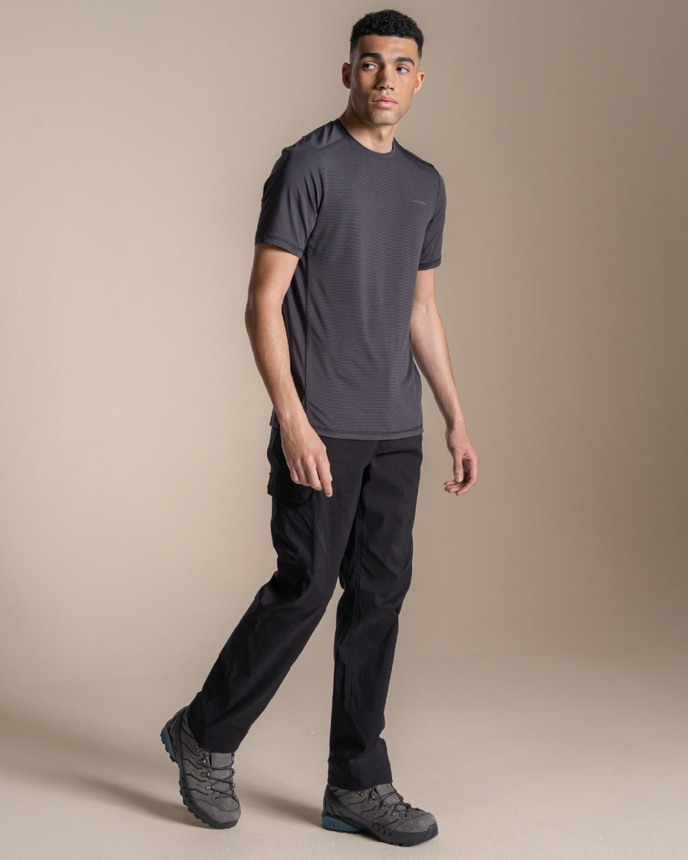 Black coloured Craghoppers Mens Brisk Pro Trouser on beige background 