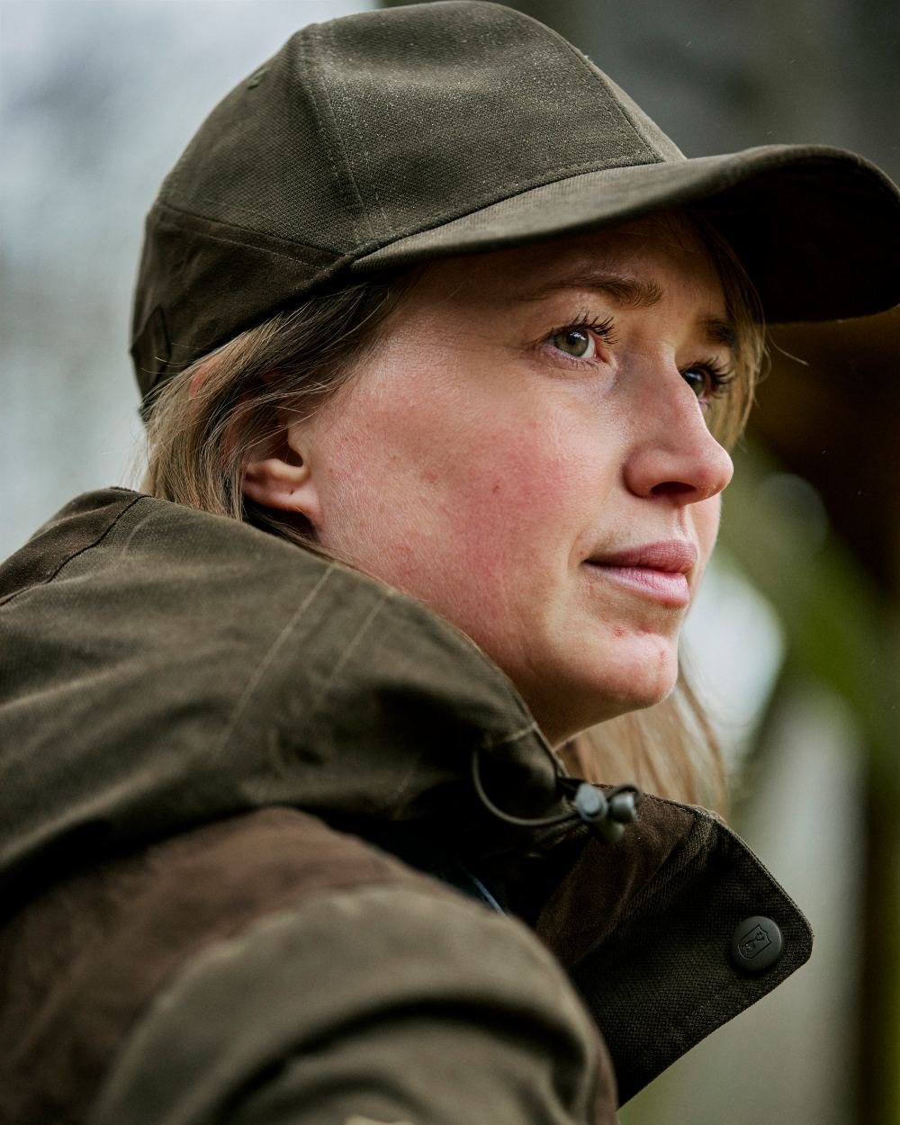 Tarmac Green Coloured Deerhunter Eagle Cap On A Forest Background 