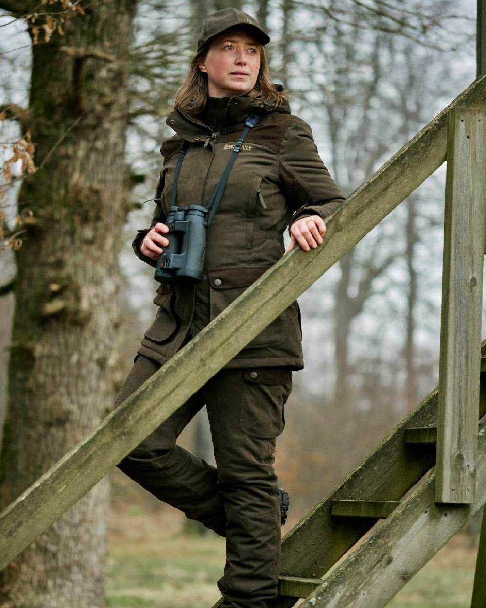 Tarmac Green Coloured Deerhunter Eagle Cap On A Forest Background 