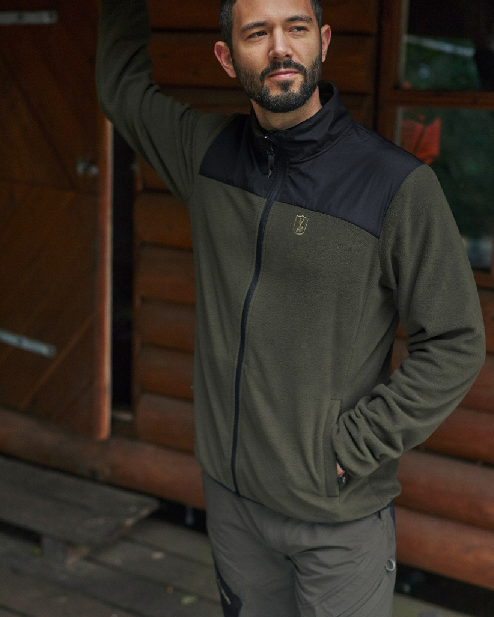 Bark Green Black coloured Deerhunter Northward Trousers on Wooden Background 