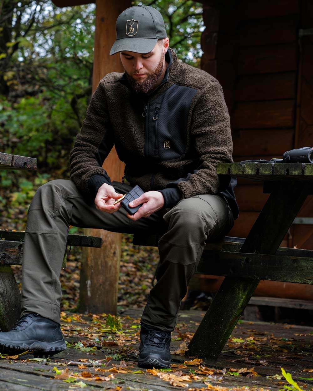 Bark Green coloured Deerhunter Northward Trousers on Forest Background 