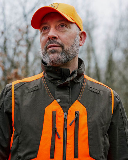 Orange coloured Deerhunter Shield Cap on Forest background 