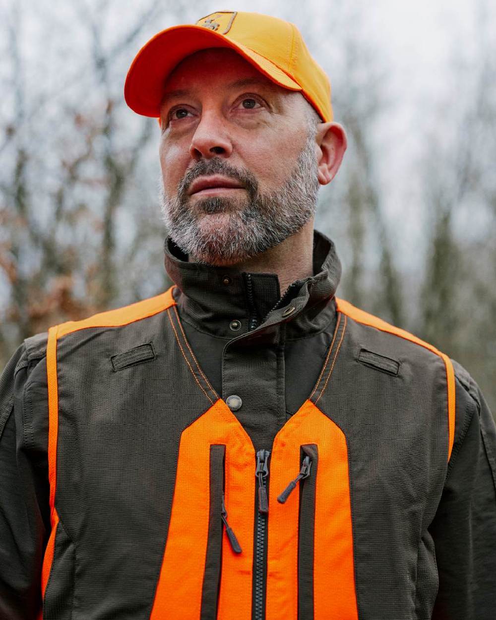 Orange coloured Deerhunter Shield Cap on blurry background 