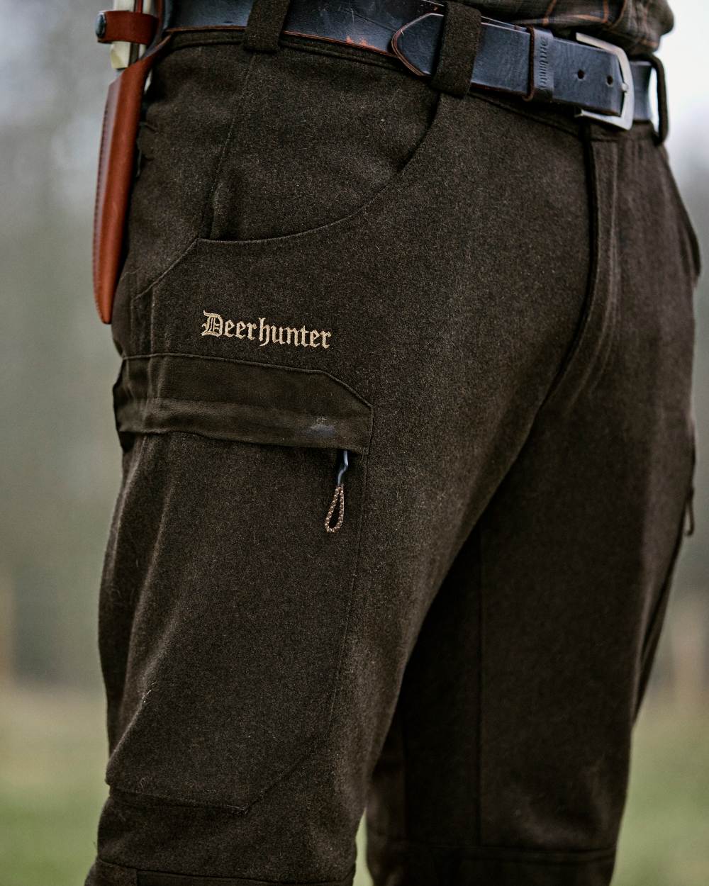 Loden Wood coloured Deerhunter Tatra Trousers on forest background 