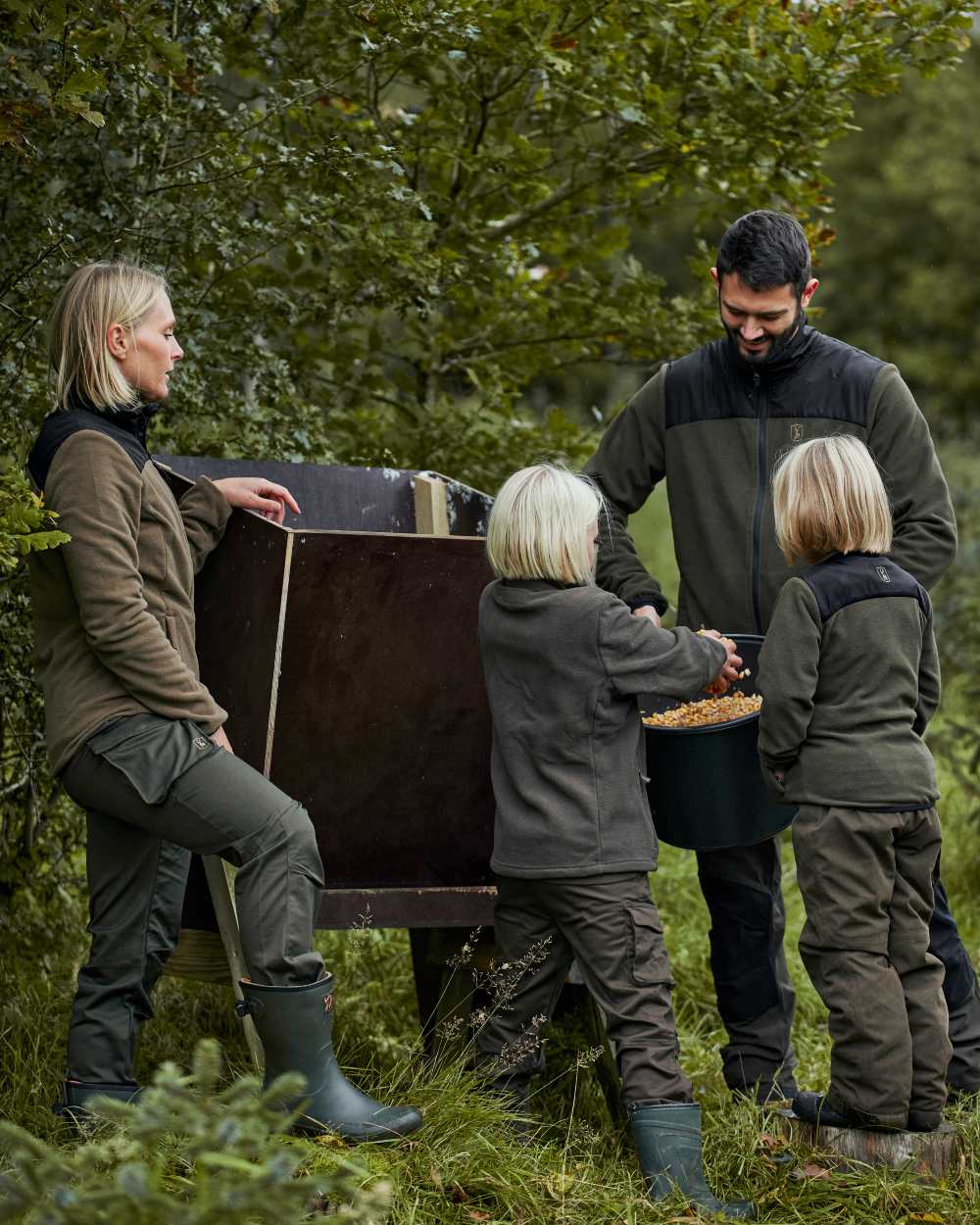 Tarmac Green coloured Deerhunter Youth Eagle Winter Trousers on Forest background 