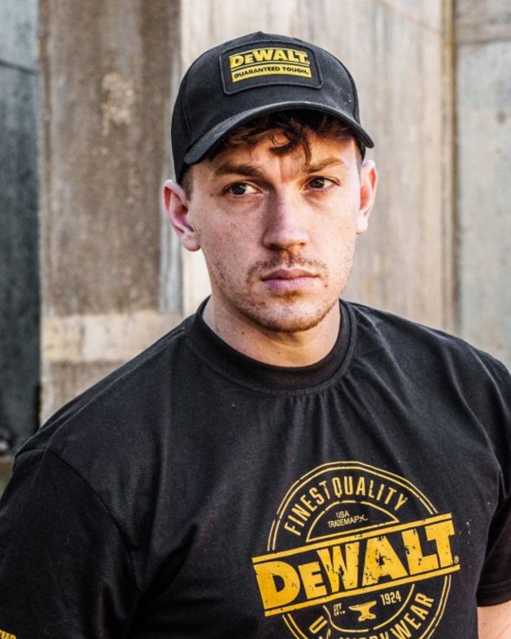 Black Coloured DeWalt Oakdale Baseball Cap On A Street Background