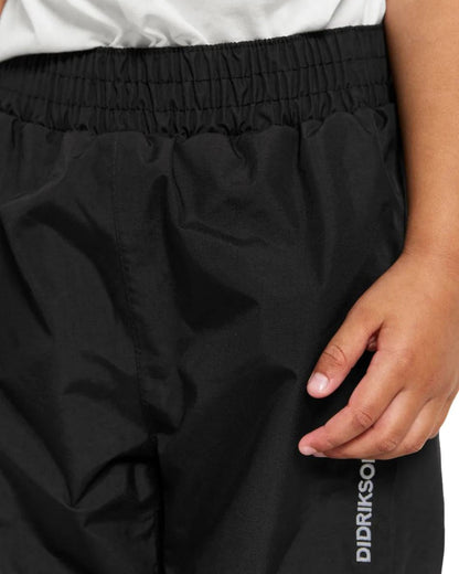Black Coloured Didriksons Idur Childrens Pants On A White Background 
