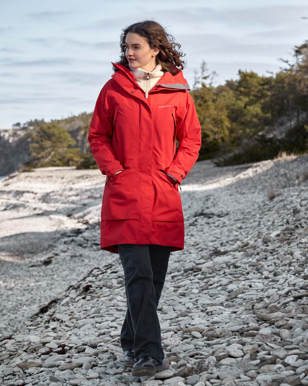 Pomme Red coloured Didriksons Womens Parka on beach background 