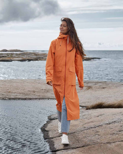 Faded Brique coloured Didriksons Nadja Parka on Ocean background 
