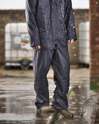 Navy Coloured Fort Airflex Waterproof Breathable Trousers On A Brick Wall Background 
