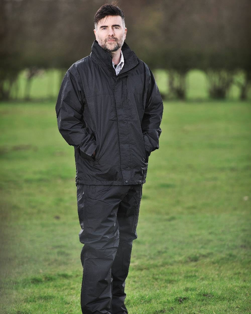 Black Coloured Fort Rutland Waterproof Jacket On A Field Background