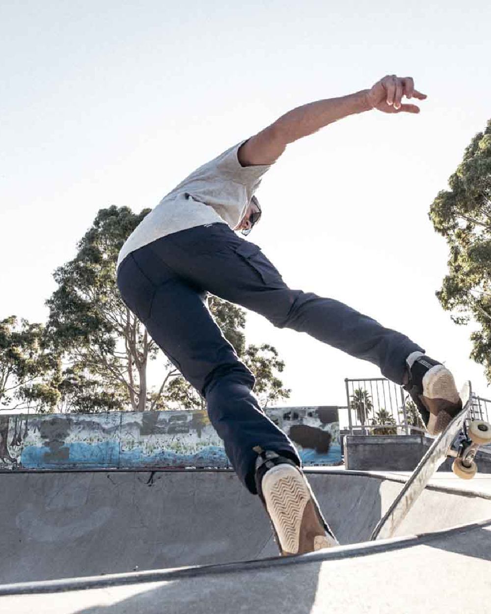 Navy Coloured Hard Yakka Mens Raptor Active Trousers on Skatepark Background
