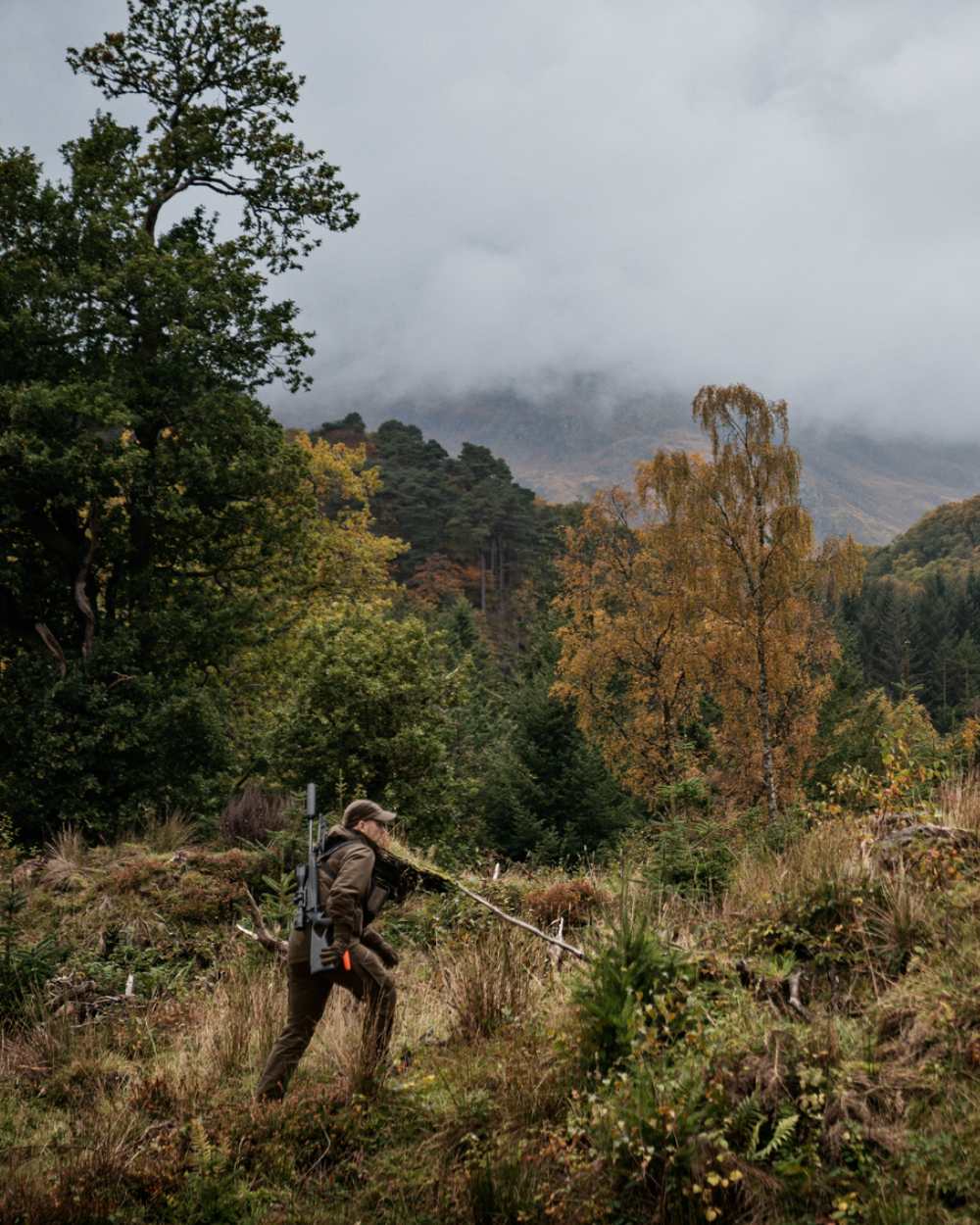 Hunting Green Shadow Brown Coloured Harkila Forest Hunter GTX Jacket On A Forest Background