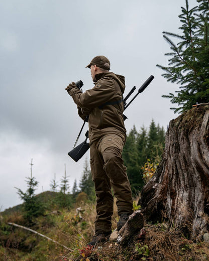 Hunting Green Shadow Brown Coloured Harkila Forest Hunter GTX Jacket On A Forest Background