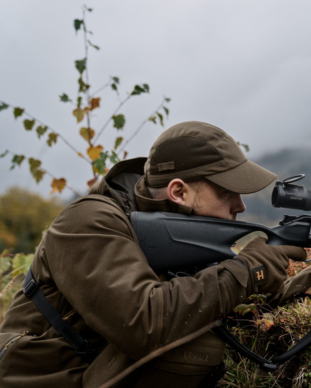 Hunting Green Shadow Brown Coloured Harkila Forest Hunter GTX Jacket On A Forest Background