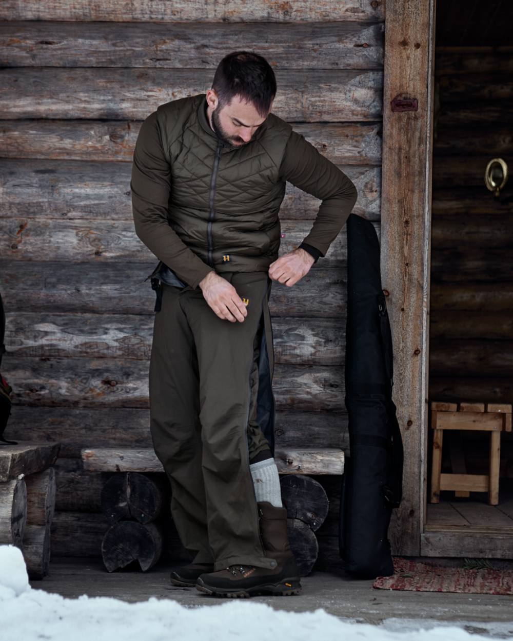 Willow Green Coloured Harkila Logmar Insulated Packable Knee Breeches On A Wooden House Background 