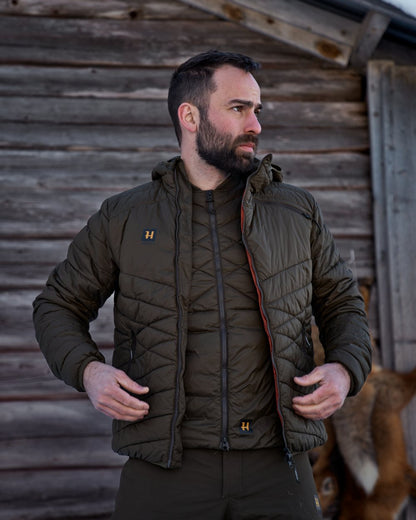 Willow Green Coloured Harkila Logmar Insulated Packable Waistcoat On A Woody House Background