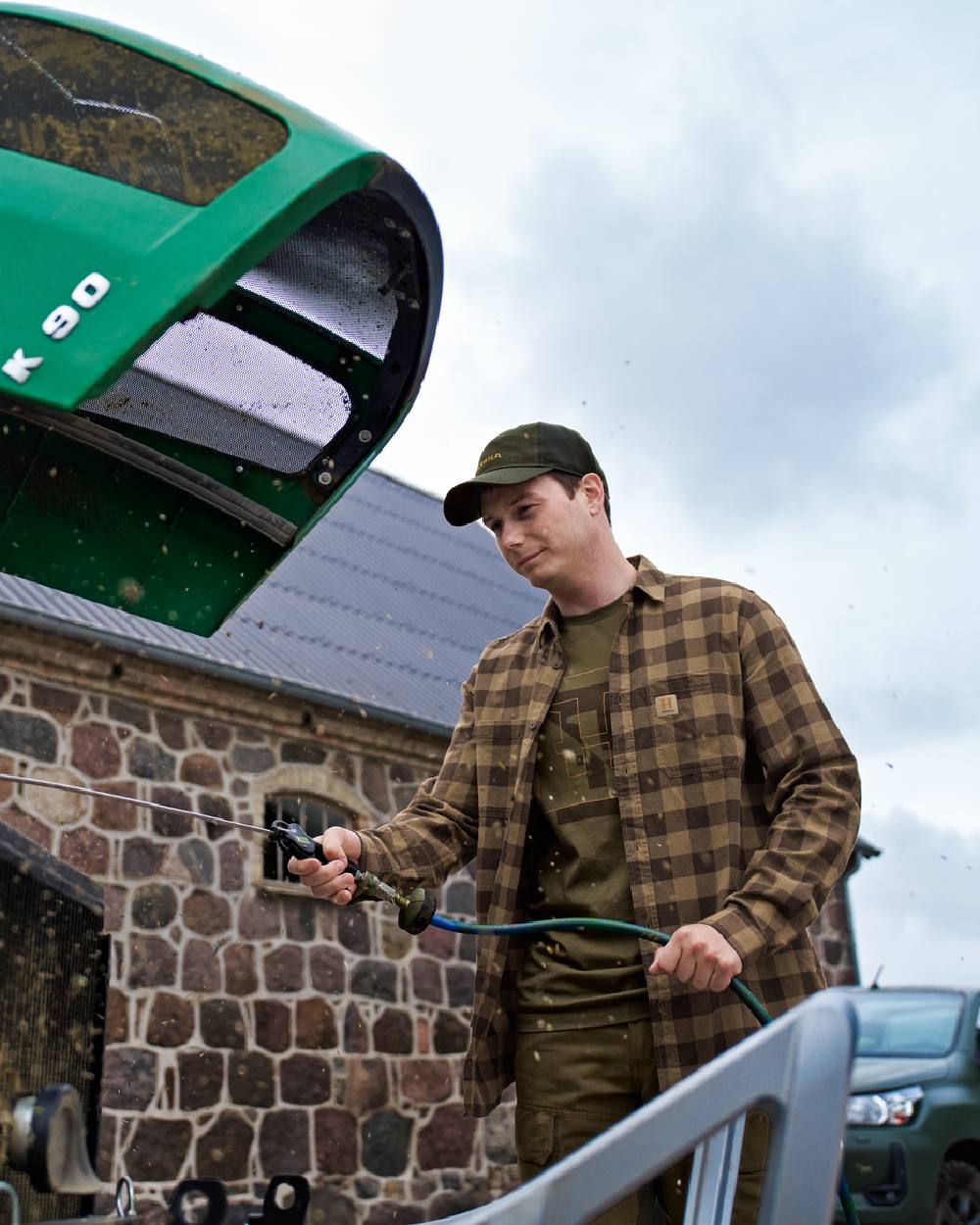 Dark Olive Coloured Harkila Mens H-Logo Short Sleeve T-Shirt on Outdoor Background
