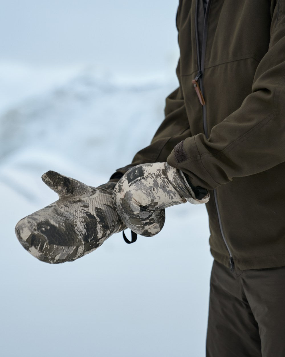 AXIS Mountain Coloured Harkila Mountain Hunter Expedition HWS Down Mittens On A Snow Background