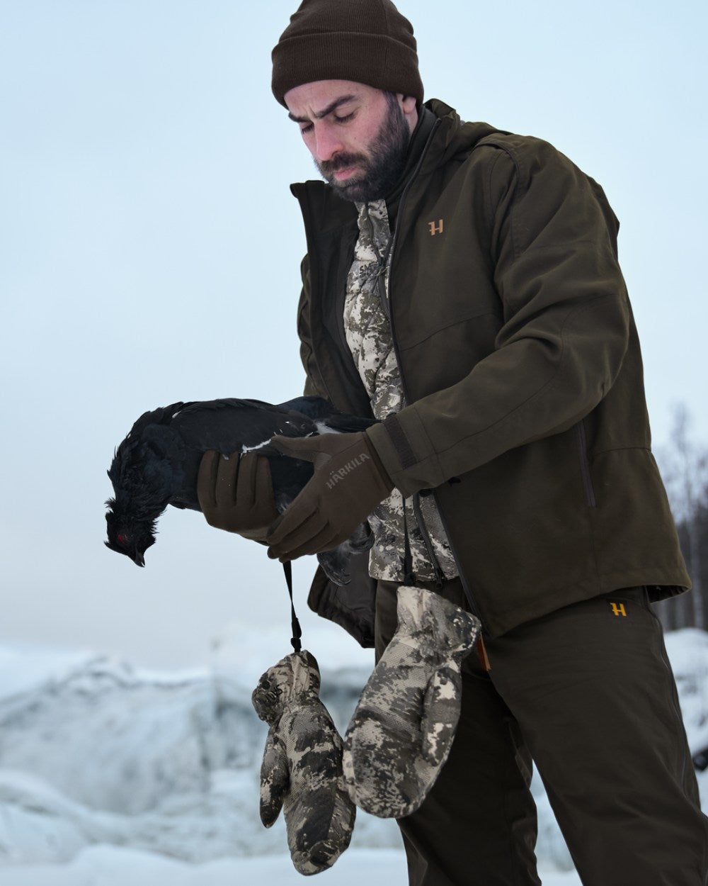 AXIS Mountain Coloured Harkila Mountain Hunter Expedition HWS Down Mittens On A Snow Background