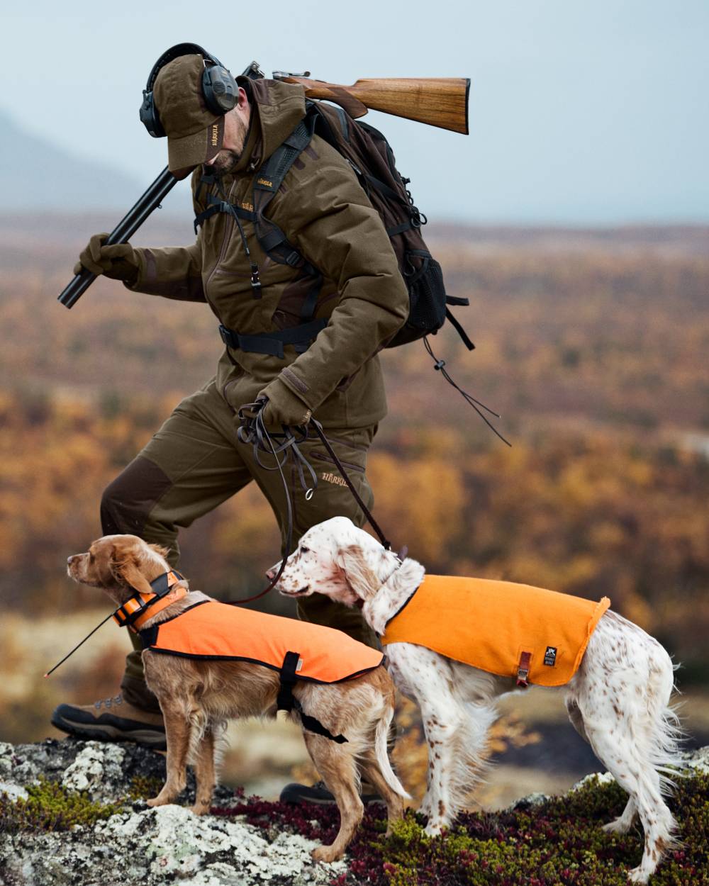 Hunting Green Shadow Brown Coloured Harkila Mountain Hunter Jacket On A Forest Background