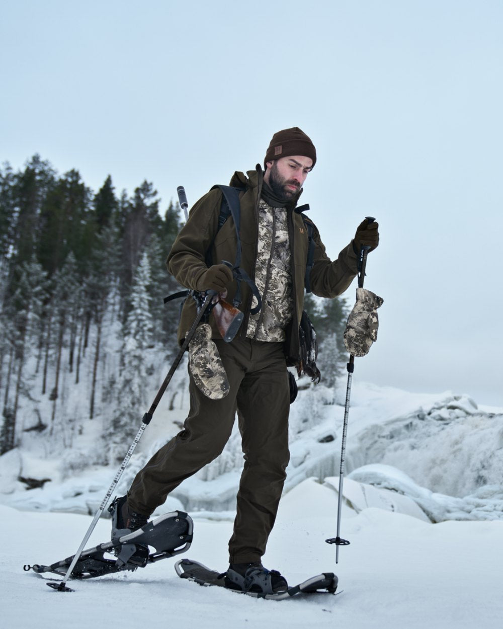 AXIS Mountain Coloured Harkila Camo HSP Insulated Waistcoat on snow background 
