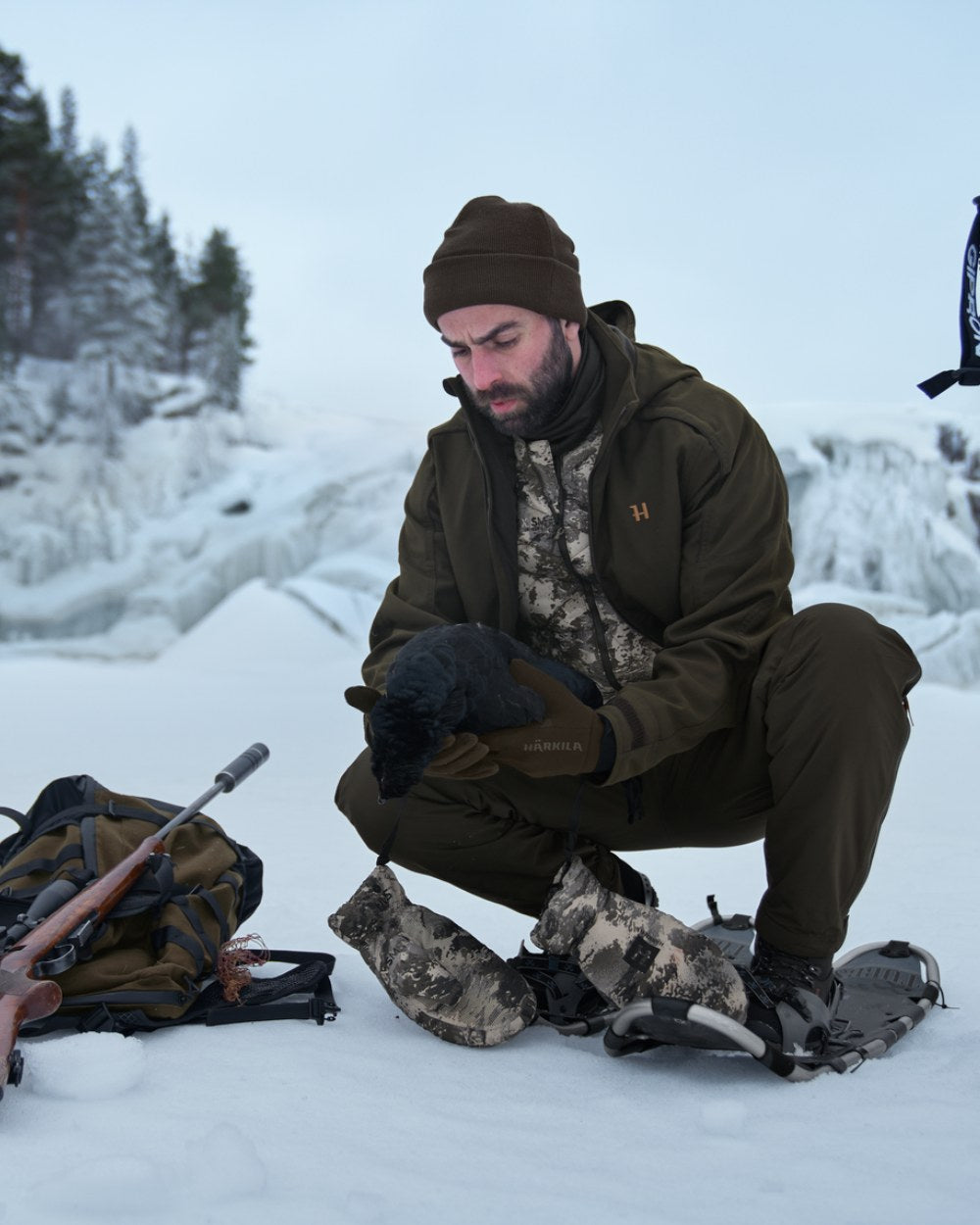 AXIS Mountain Coloured Harkila Camo HSP Insulated Waistcoat on snow background 