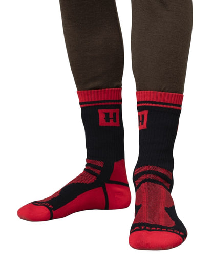 Black Red Coloured Harkila Waterproof Socks On A White Background