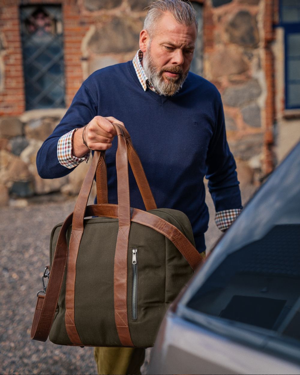 Warm Olive Coloured Harkila Weekend Bag 30 L On A Street Background