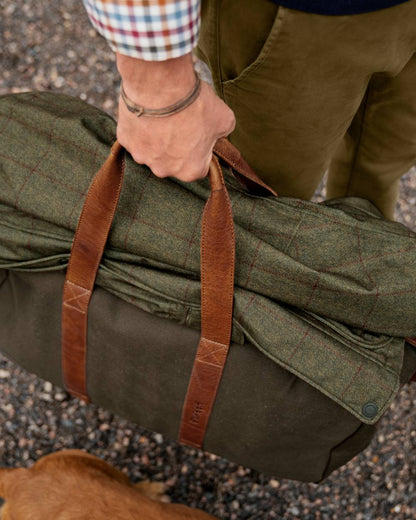 Warm Olive Coloured Harkila Weekend Bag 30 L On A Street Background