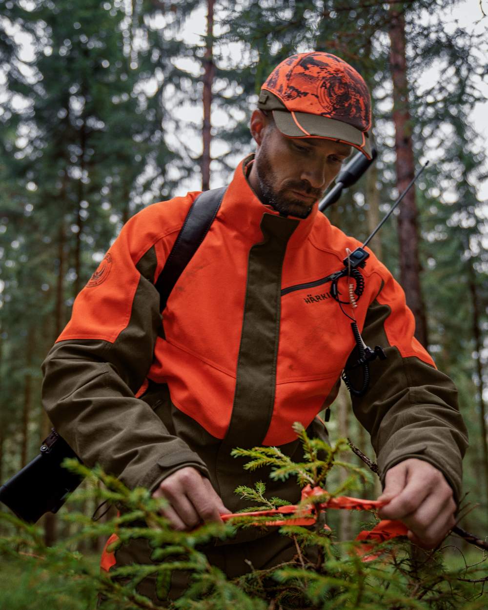 Wildboar Orange Willow Green Coloured Harkila Wildboar Pro Jacket On A Forest Background