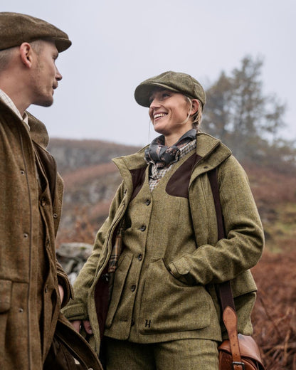 Olive Coloured Harkila Womens Jura Shooting Waistcoat On A Forest Background