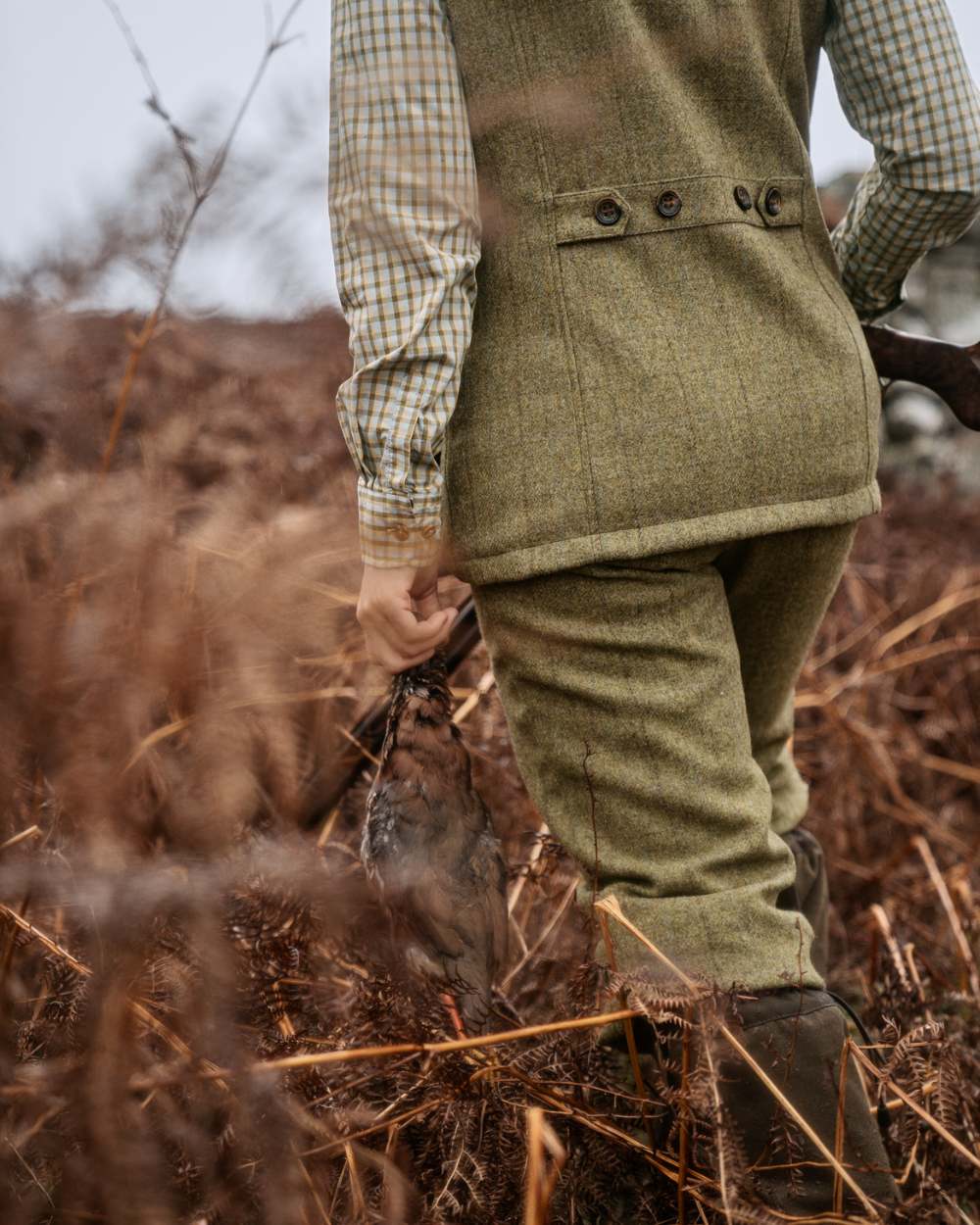 Olive Coloured Harkila Womens Jura Waistcoat On A Forest Background