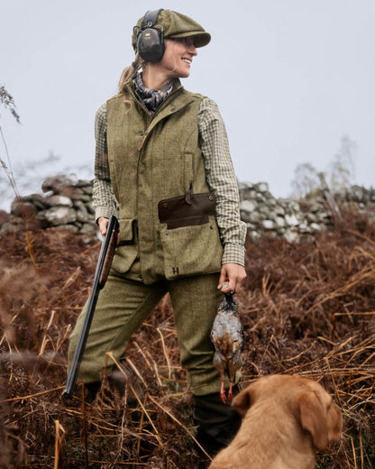 Olive Coloured Harkila Womens Jura Waistcoat On A Forest Background