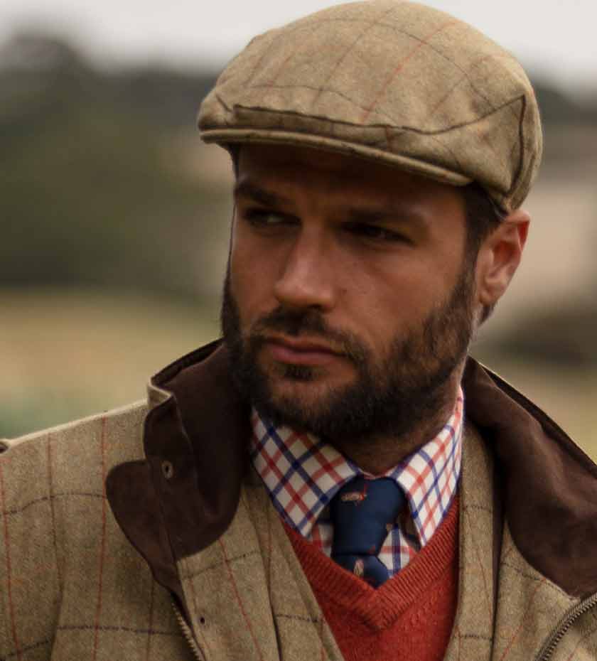 Men's Hats and Caps. Man wears Light green tweed flat cap with shirt and tie.