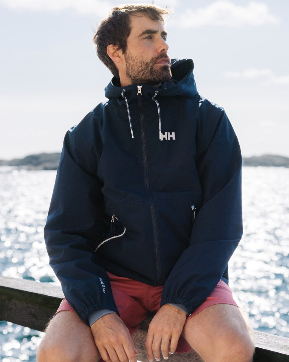 Washed Red Coloured Helly Hansen Mens Dock Shorts on Beach Background
