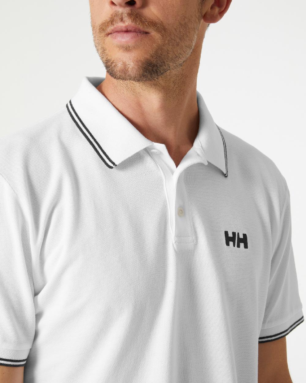 White coloured Helly Hansen Mens Genova Polo T-Shirt on grey background 